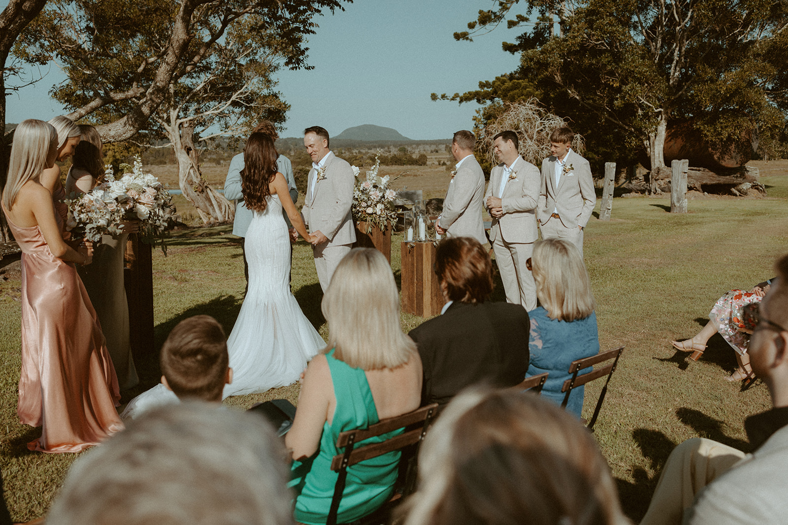 The bridal party celebrating together outdoors in green and rust tones
