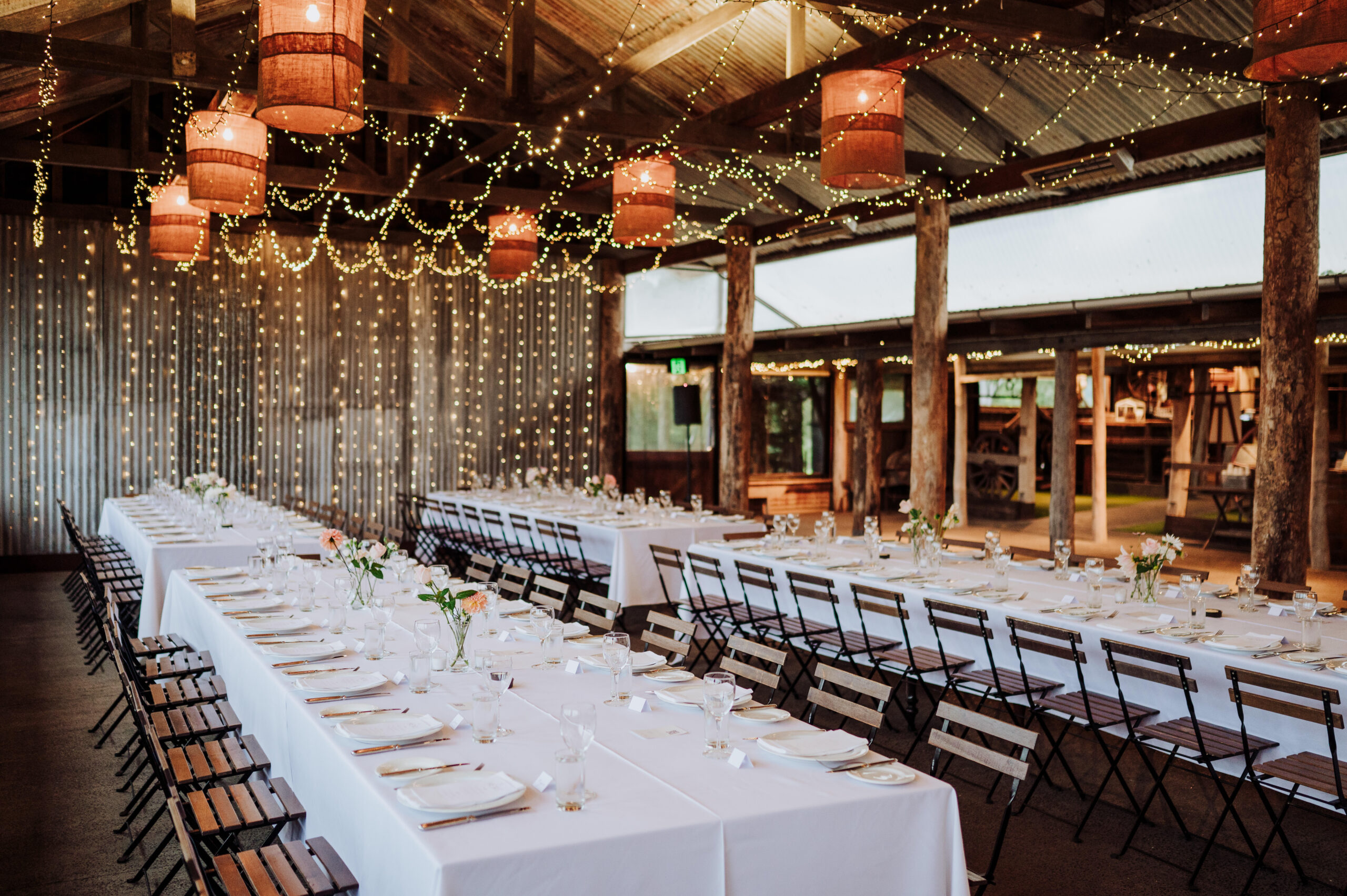 The Dairy Barn set for a reception, timber posts and windows onto the pasture