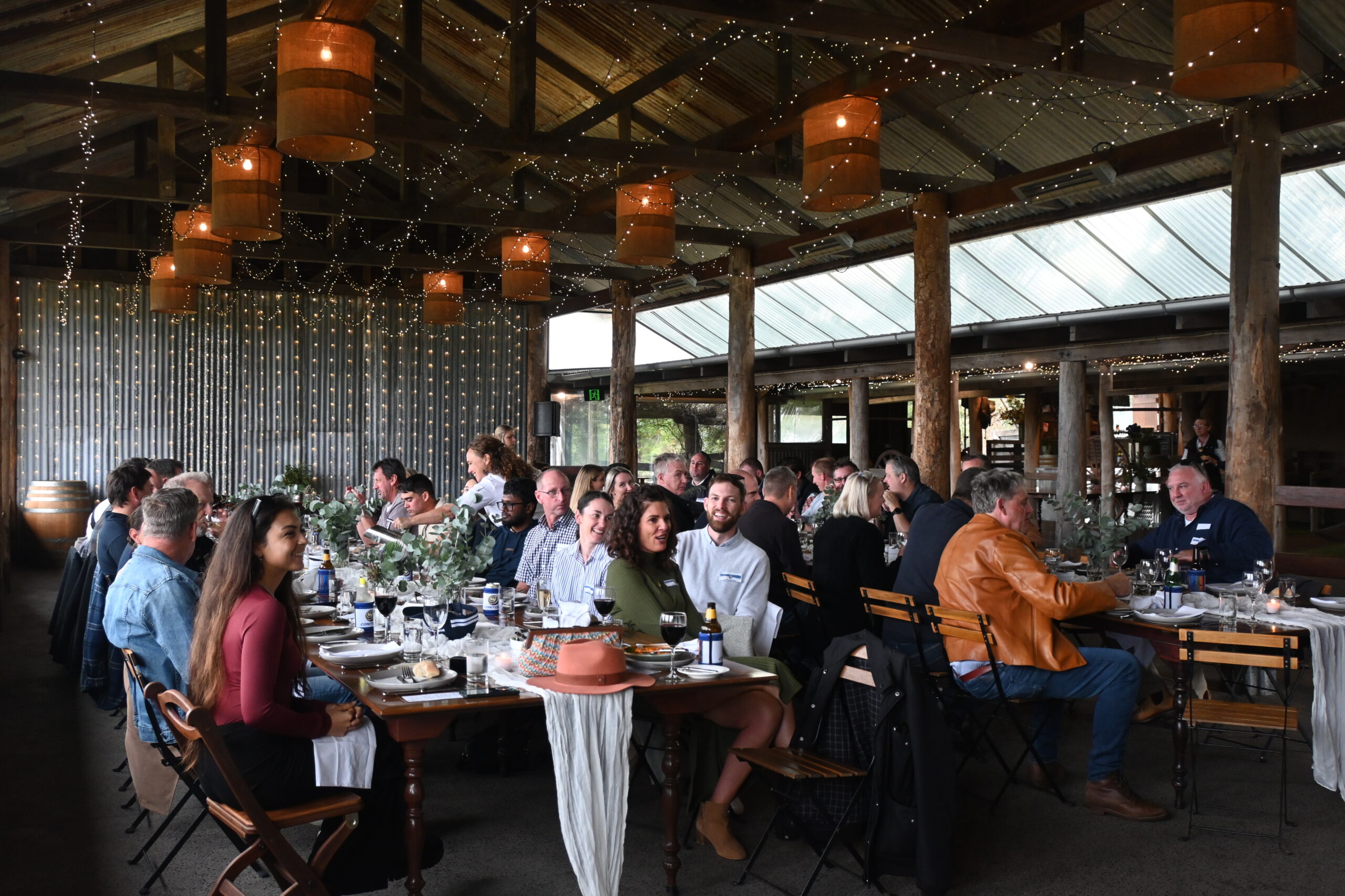 Guests seated along the reception tables in the Dairy Barn